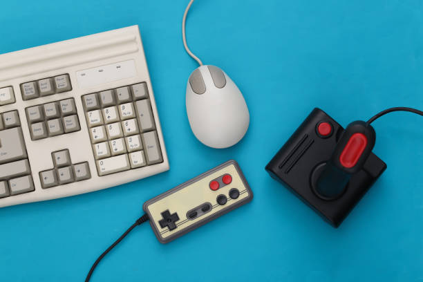istock Old keyboard, joystick, gamepad and pc mouse on blue background. Retro gaming. 80s. Top view 1312308135