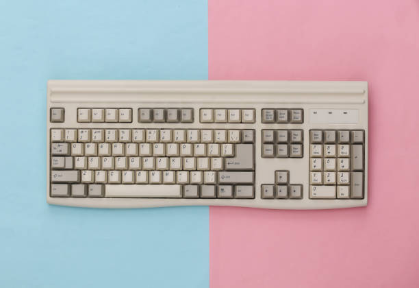 istock Old pc keyboard on blue pink background. Top view. Flat lay 1312308862