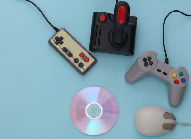 istock Different retro gamepads and joysticks, pc mouse, cd's on blue background. Video game.  Flat lay, top view 1312308947