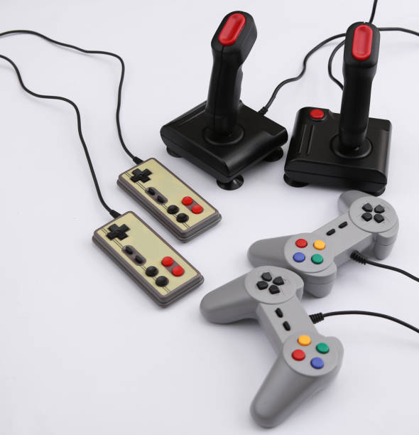 istock Retro gamepads and joysticks on white background. Video game, gaming 80s. 1312309249
