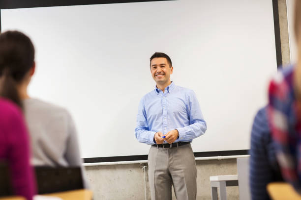 istock group of students and smiling teacher in classroom 1312309394