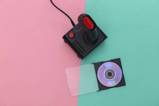 istock Retro joystick and CD in box on pink blue pastel background. Gaming, video game competition 1312309513