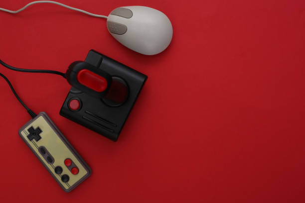 istock Retro joystick and gamepad, pc mouse on red background. Gaming, video game competition. Top view 1312309619