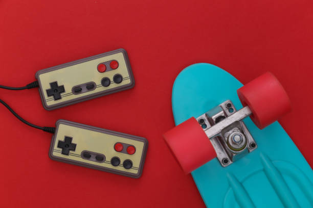 istock Youth fun. Retro gempads, cruiser board on red background. 80s. Flat lay, top view 1312309676