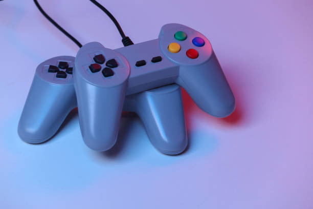 istock Retro gamepad in red blue gradient neon light. Gaming, video game competition. 1312310375