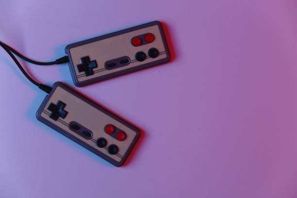 istock Retro gamepad in red blue gradient neon light. Gaming, video game competition. Top view 1312310431