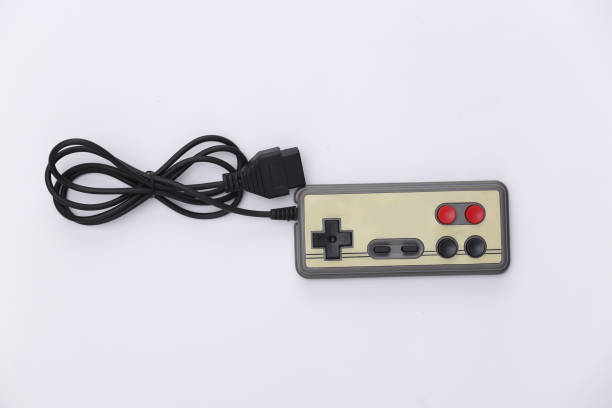 istock Wired retro gamepad (joystick) with wound cable on white background. Video game, gaming. Top view 1312310585