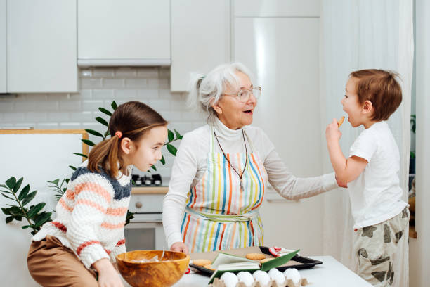 istock Siblings visiting their grandmother, they make cook together. 1312310728