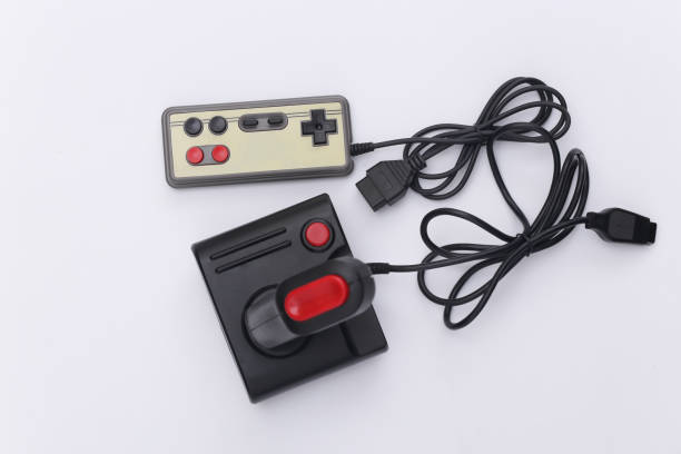istock Wired retro gamepad and joystick with wound cable on white background. Video game, gaming. Top view 1312310782