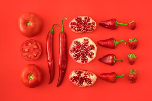 Vibrant chilli peppers. Assorted colorful varieties of hot and sweet peppers or chilies on a farm background. copy space.