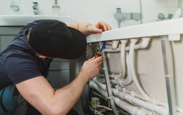 istock Man installing pipe system of bathtub with hydromassage. 1312311814
