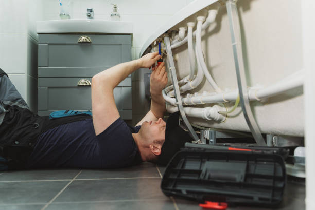 istock Man installing pipe system of bathtub with hydromassage. 1312311815