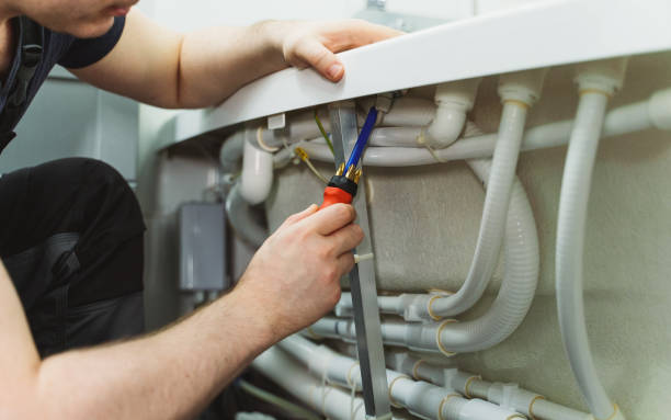 istock Man installing pipe system of bathtub with hydromassage. 1312311817