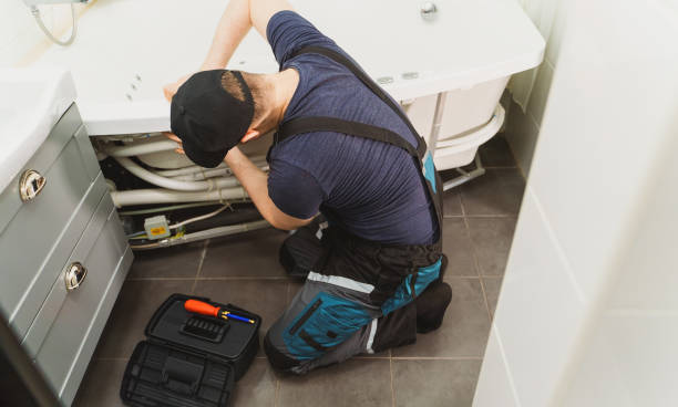 istock Man installing pipe system of bathtub with hydromassage. 1312311850