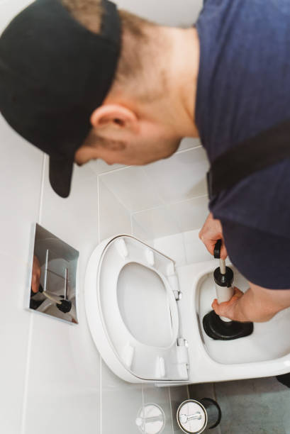 istock Plumber unclogging toilet with professional force pump cleaner. 1312311862