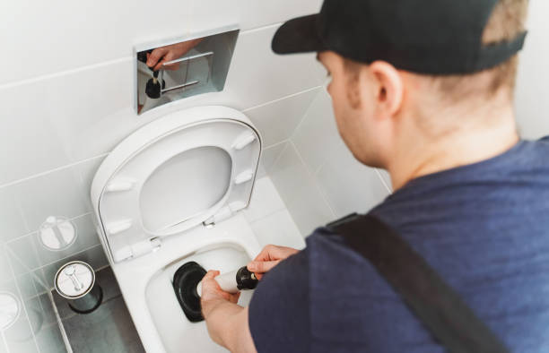 istock Plumber unclogging toilet with professional force pump cleaner. 1312311868