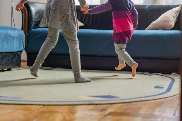 istock Low angle view of children legs running at home 1312311929