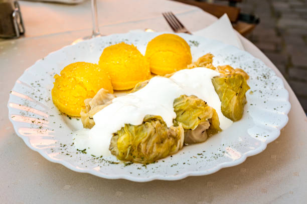 Cabbage rolls with Mamaliga Sarmale (cabbage rolls) with Mamaliga (polenta) is a popular dish in Romania mamaliga stock pictures, royalty-free photos & images