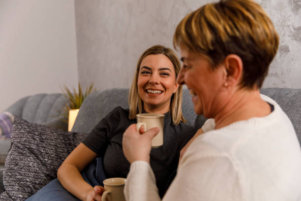 istock Mother and daughter having a laugh while drinking coffee together 1312312233