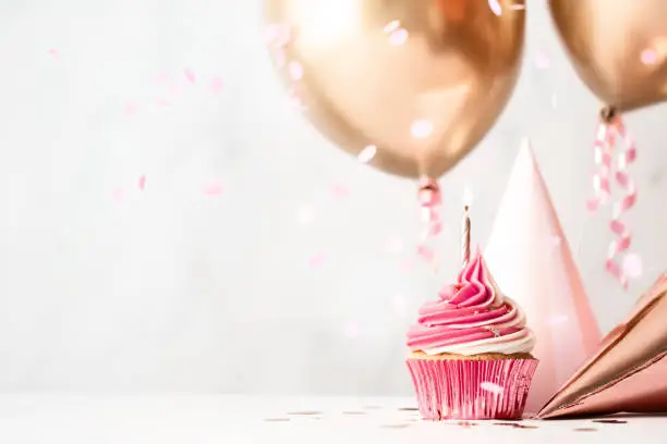 Photo of Birthday celebration with cupcake and balloons