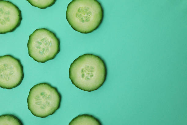 istock Fresh ripe cucumber slices on mint background 1312313575