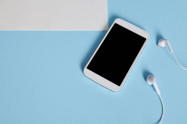 istock Flat lay composition of white gadgets on blue background 1312313705
