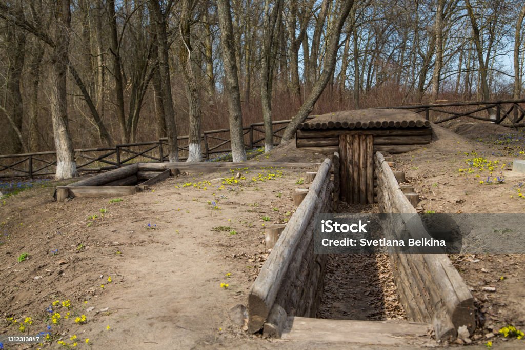 A trench fortified with logs with a dugout. Victory Day. The Second World War. Monument to the fallen soldiers. Trench Stock Photo