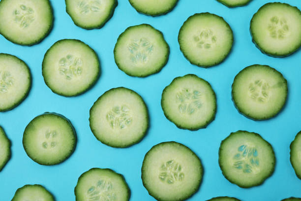 istock Fresh ripe cucumber slices on blue background 1312313932