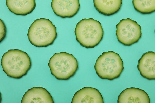 istock Fresh ripe cucumber slices on mint background 1312314643