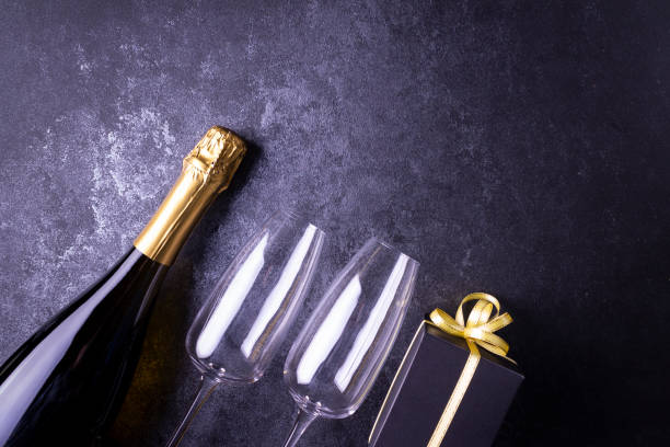 istock Alcohol, two glasses, a box with a gift on a blue background. Flat lay. 1312314669