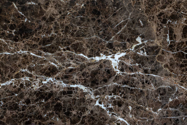 istock Polished brown marble with white veins as a natural background, texture. 1312315300