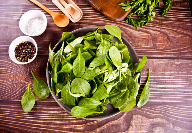 istock spinach in the bowl on the dark wooden background 1312316801
