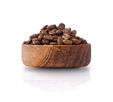 Coffee beans in a wooden bowl isolated on a white background