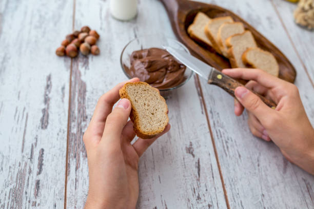 Spreading chocolate cream on a toast