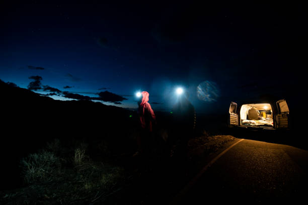 istock Couple walking at night while camping in their van 1312318008