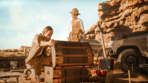 Archaeological Digging Site: Two Great Adventurers on Treasure Hunt Talk and work with Opened Chest with Unspeakable Treasures. Ancient Civilization Hidden Gold Found