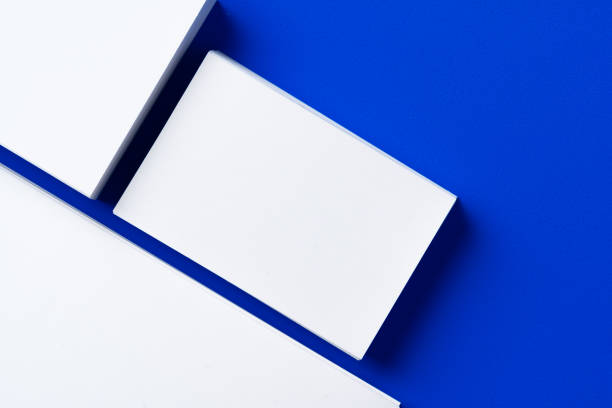 Blank white businesscards on classic blue background