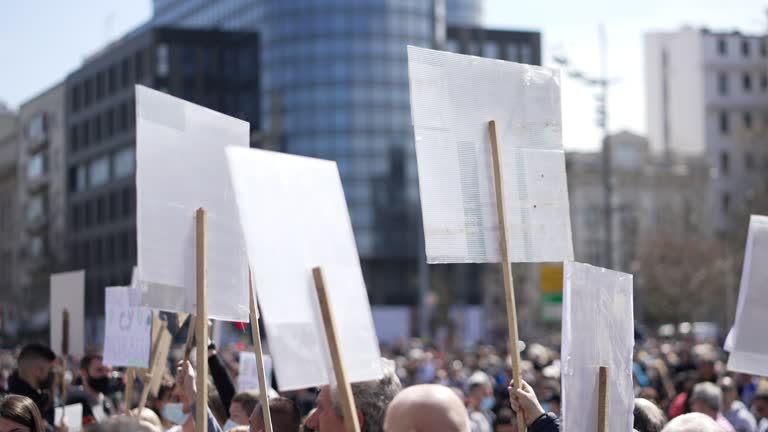 Activists during protest, holding banner and signs, dissatisfied with unemployment because of a COVID-19 restriction and state lockdown