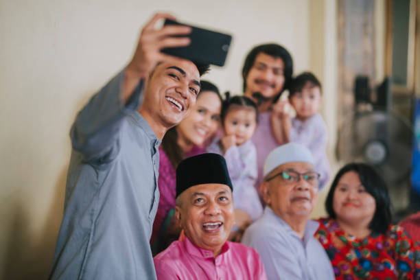 família malaia malaia malaia malaia tirando foto de selfie olhando para a câmera acenando em casa celebrando hari raya - great granddaughter - fotografias e filmes do acervo