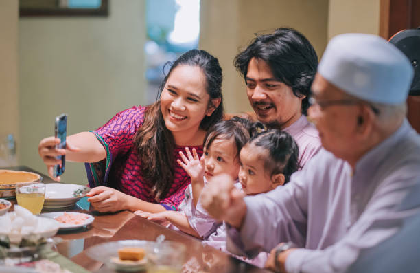 istock Iftar ramadan hari raya malaysian muslim multi generation family waving videocall relative enjoying dinner at home in dining room 1312319291