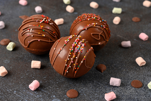Cocoa bombs with marshmallows, chocolate that melts when hot milk is added for creating a trendy tasty drink.