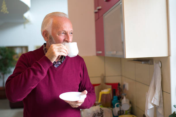 istock Senior man drinking coffee in the kitchen 1312326668