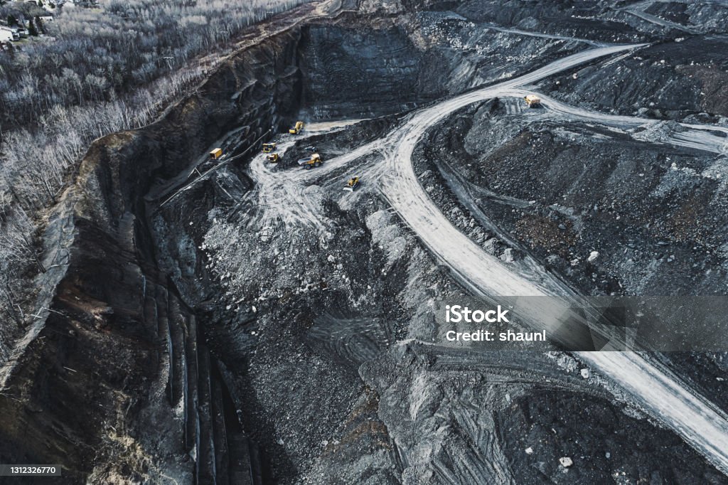 Aerial View Of Coal Mine Aerial drone view of an open pit coal mine. Mining - Natural Resources Stock Photo