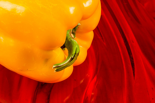 a colorful mix of the freshest red and yellow paprika, bell pepper on red background, close up