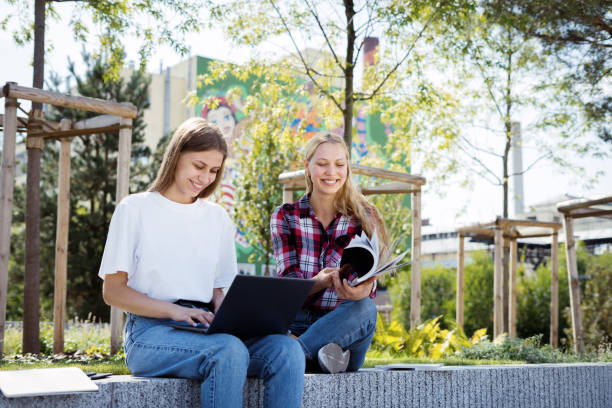 istock Two young university student girl spending time near campus 1312327617