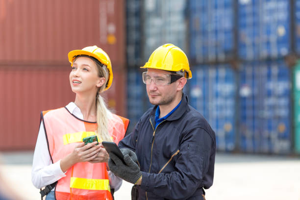 istock Engineers are using mobile phones in the port of loading goods. Warehouse workers. 1312327922