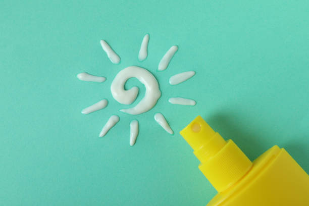 istock Sunscreen and sun made of cream on mint background 1312328890