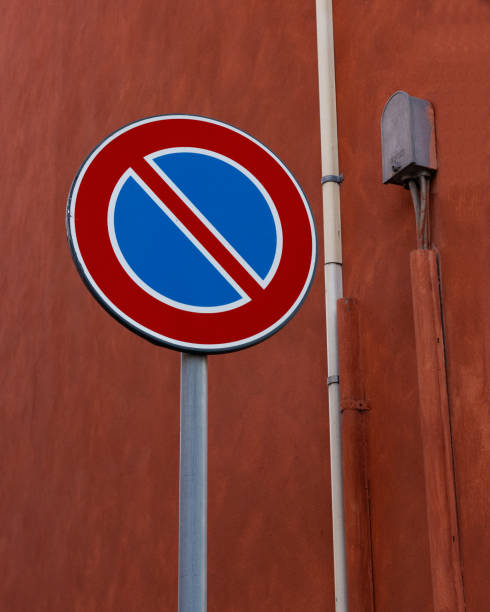 istock No parking sign on red wall in nice composition 1312328925