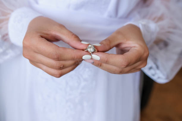 istock Gold ring with a stone in the hands of the bride 1312329320