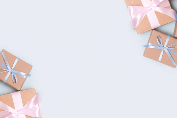 istock Frame made of gift boxes on a blue pastel background. Present tied ribbon. 1312331832